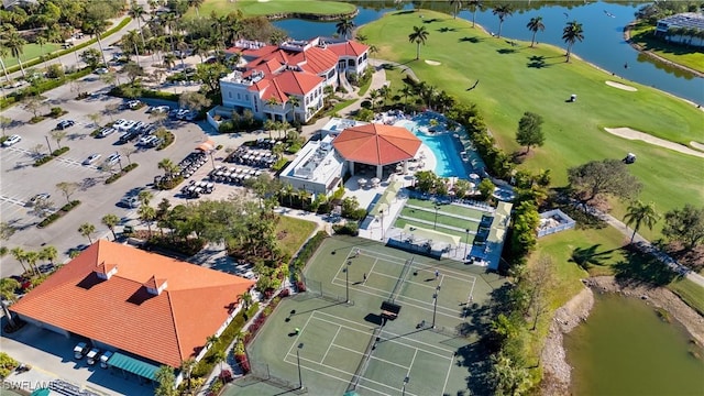 aerial view with golf course view and a water view