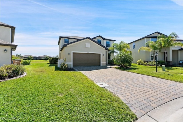 view of front of property featuring a garage, a front lawn, decorative driveway, and stucco siding