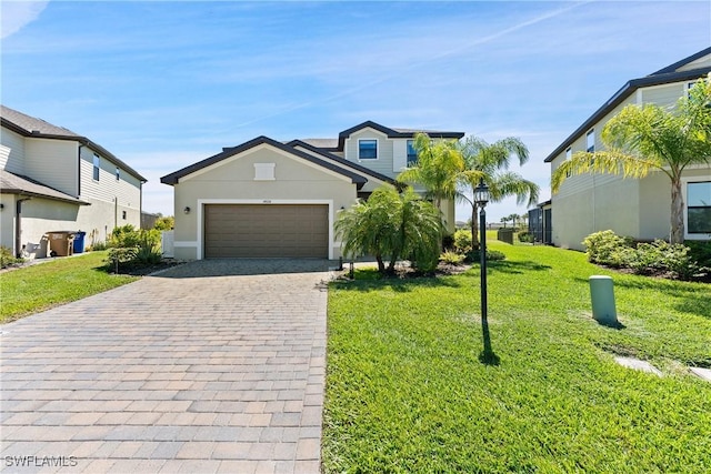 view of front of property with an attached garage, decorative driveway, and a front yard