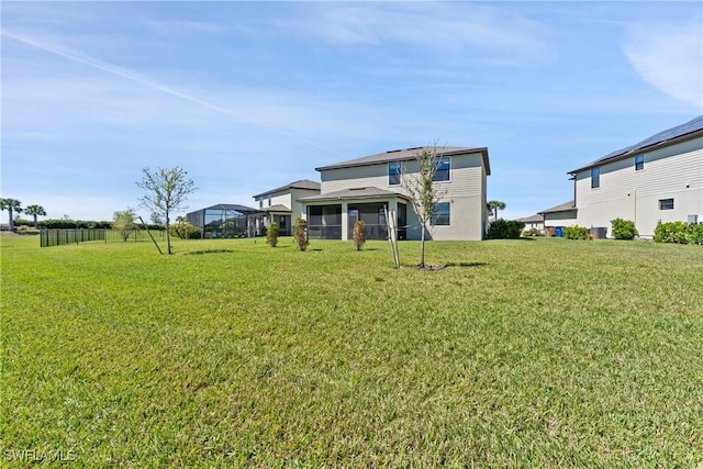 rear view of property with a lawn