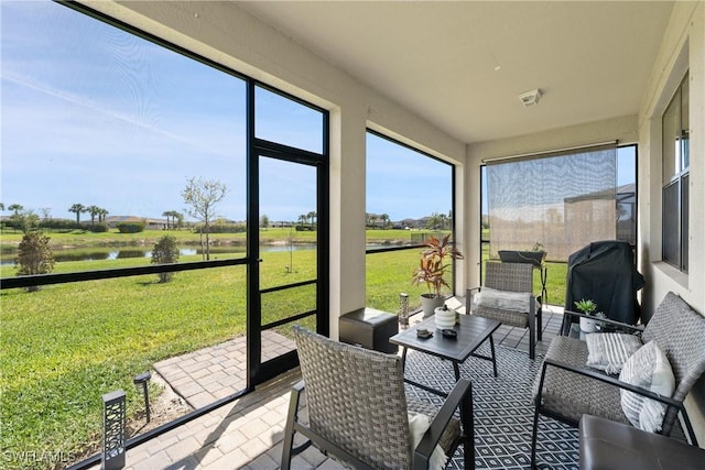 sunroom / solarium with a water view