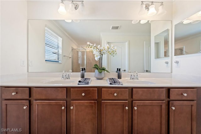 full bathroom with ornamental molding, a stall shower, a sink, and visible vents