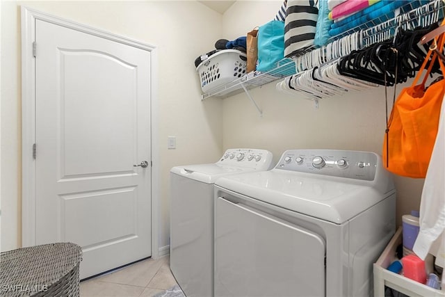 washroom with laundry area, light tile patterned flooring, and independent washer and dryer