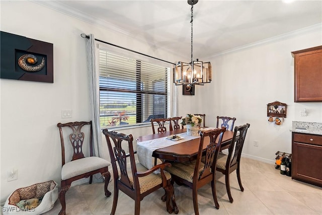 dining room with light tile patterned floors, ornamental molding, an inviting chandelier, and baseboards