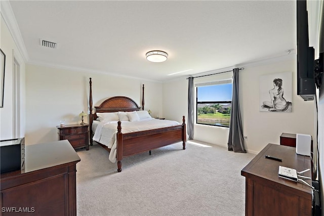 bedroom with light colored carpet, visible vents, and crown molding