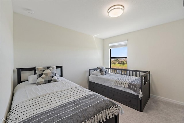 carpeted bedroom with baseboards