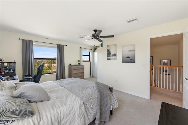 bedroom featuring baseboards, a ceiling fan, visible vents, and light colored carpet