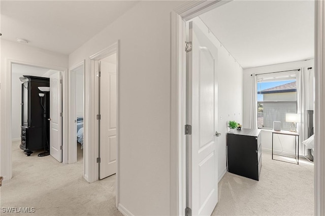 hallway with light colored carpet