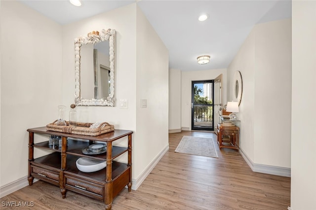 entryway featuring recessed lighting, baseboards, and wood finished floors