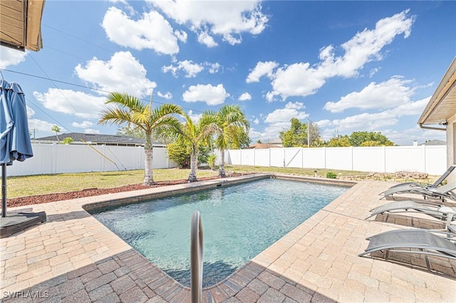 view of pool featuring a fenced in pool, a patio area, a fenced backyard, and a lawn