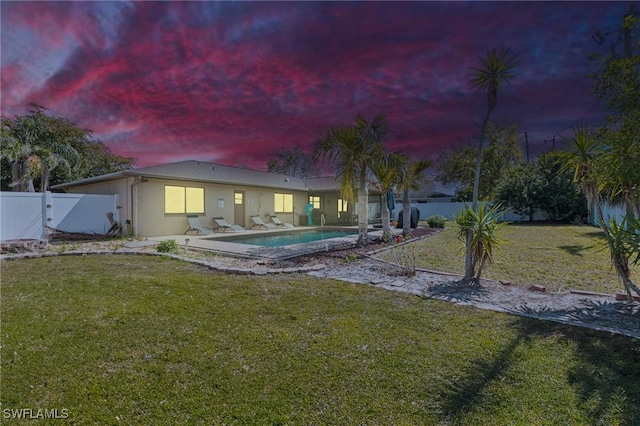 back of property with a fenced in pool, a lawn, a gate, a patio area, and a fenced backyard