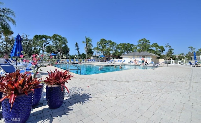 pool featuring a patio area and fence