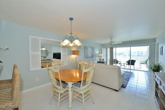 dining room with ceiling fan with notable chandelier, light tile patterned floors, and baseboards