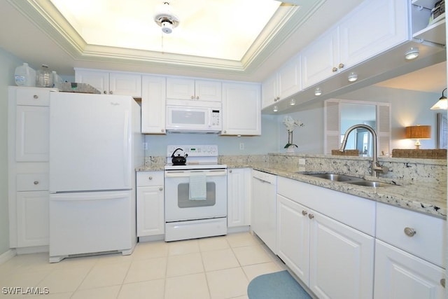 kitchen featuring a raised ceiling, ornamental molding, white cabinetry, a sink, and white appliances