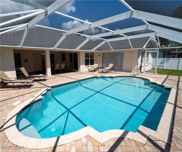 1822 SE 20th St, Cape Coral, FL 33990 - view of pool featuring glass enclosure, a patio, a fenced in pool, and fence