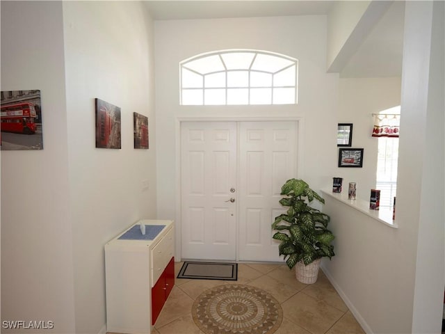 1822 SE 20th St, Cape Coral, FL 33990 - tiled foyer with baseboards and a high ceiling