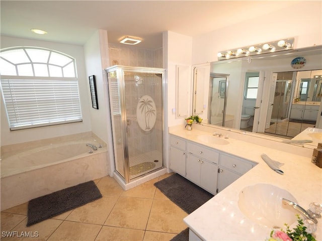 1822 SE 20th St, Cape Coral, FL 33990 - full bathroom featuring a sink, toilet, tile patterned flooring, a shower stall, and double vanity
