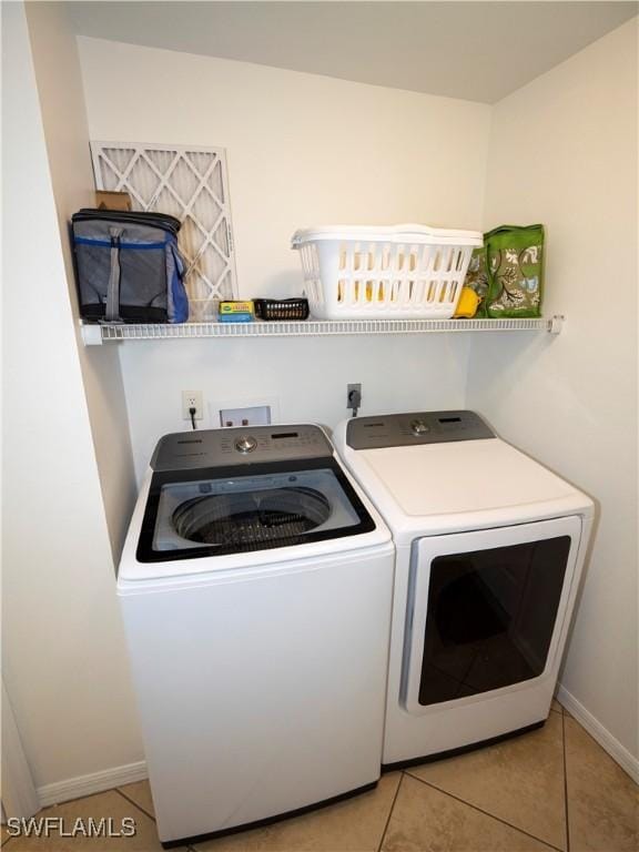 1822 SE 20th St, Cape Coral, FL 33990 - laundry area with washing machine and clothes dryer, laundry area, baseboards, and light tile patterned floors