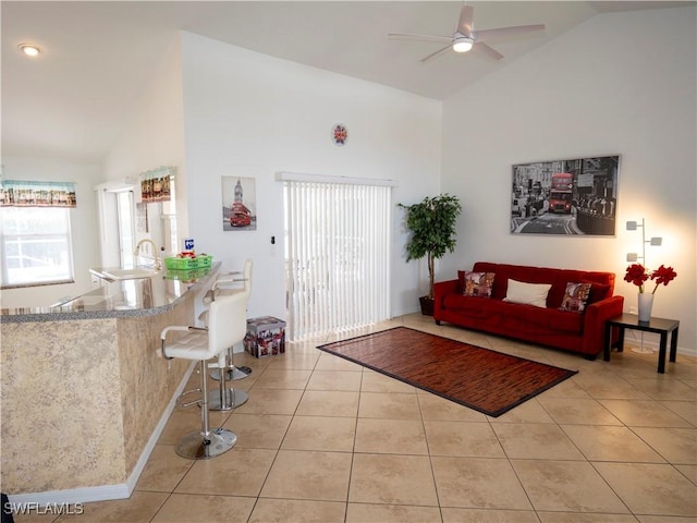1822 SE 20th St, Cape Coral, FL 33990 - living area featuring light tile patterned floors, baseboards, high vaulted ceiling, and a ceiling fan