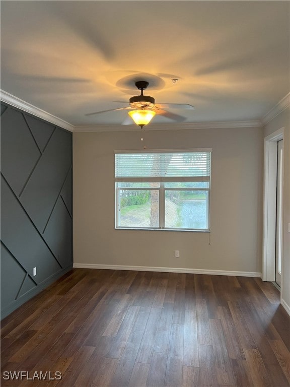 unfurnished bedroom with baseboards, dark wood-type flooring, ornamental molding, and a ceiling fan