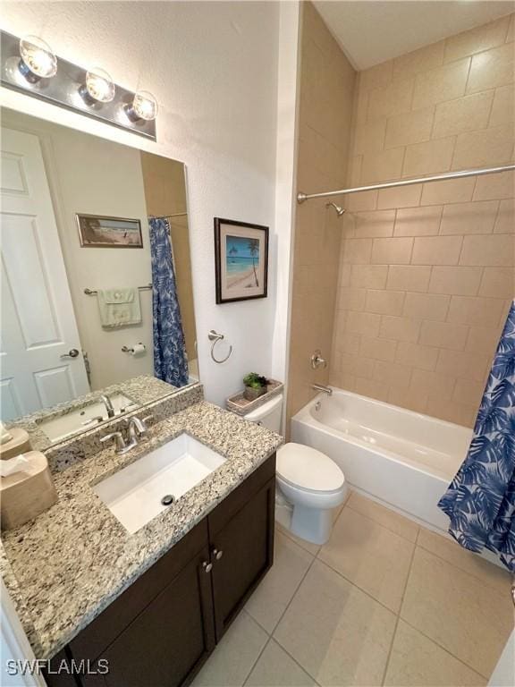 bathroom with tile patterned flooring, vanity, toilet, and shower / bath combo with shower curtain