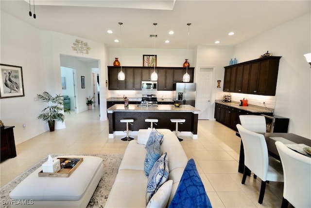 living room with light tile patterned floors, recessed lighting, and visible vents