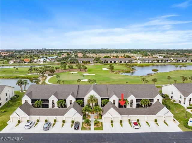 aerial view with a residential view, a water view, and view of golf course