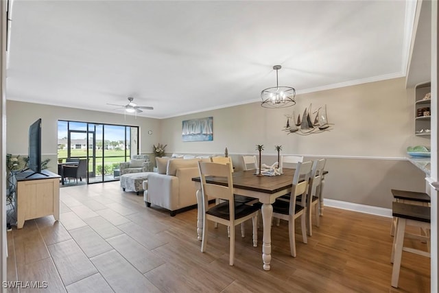 dining area featuring ceiling fan with notable chandelier, crown molding, wood finished floors, and baseboards