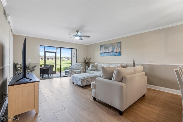 living area featuring ceiling fan, light wood-style flooring, baseboards, and ornamental molding