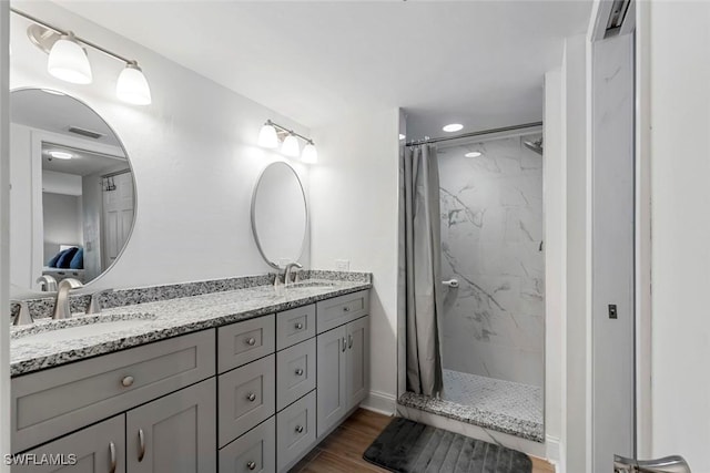 full bathroom featuring a sink, visible vents, and a stall shower