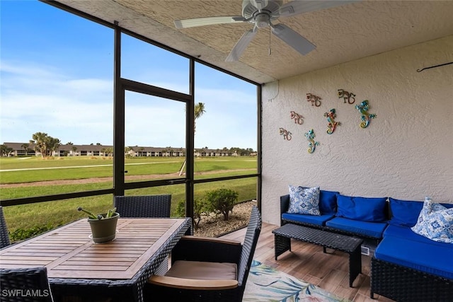 sunroom featuring a ceiling fan