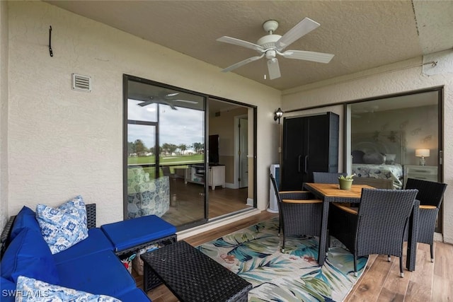 exterior space with visible vents, outdoor dining space, and a ceiling fan