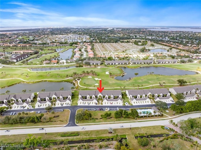 drone / aerial view with a residential view, a water view, and view of golf course