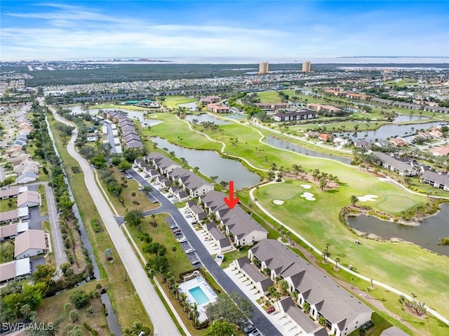 drone / aerial view with a residential view, a water view, and golf course view