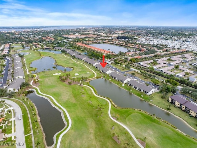 aerial view with a residential view, golf course view, and a water view