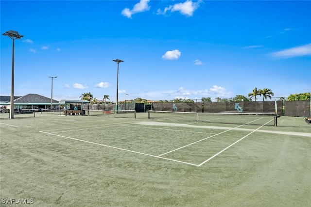 view of sport court featuring fence