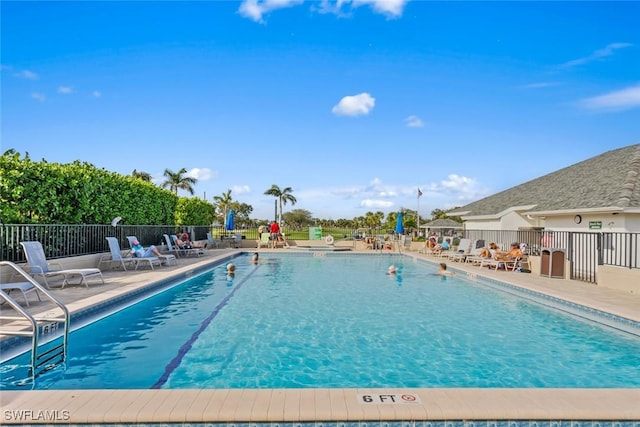 community pool featuring fence and a patio area