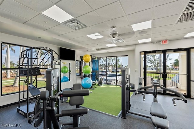 exercise room with visible vents and a drop ceiling