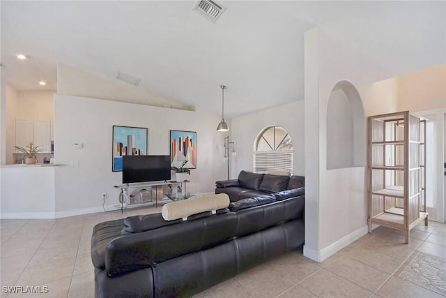 living room with lofted ceiling, light tile patterned flooring, baseboards, and visible vents