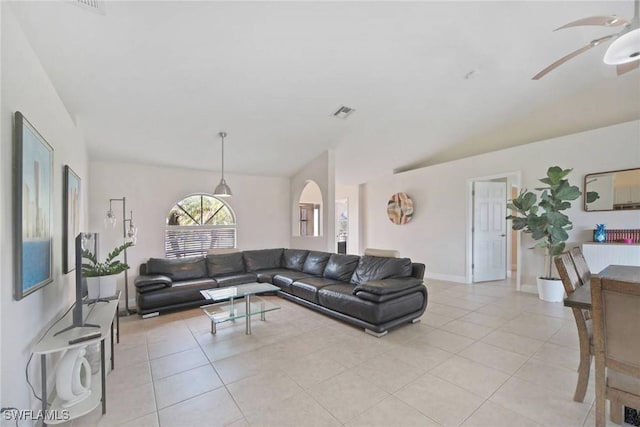 living room featuring light tile patterned flooring, visible vents, baseboards, and a ceiling fan