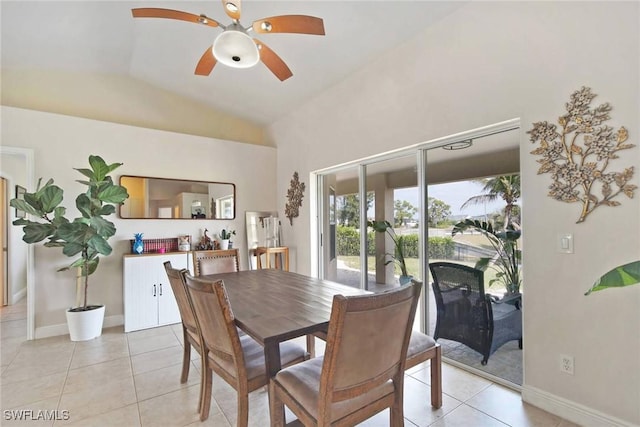 dining area featuring light tile patterned floors, baseboards, a ceiling fan, and vaulted ceiling