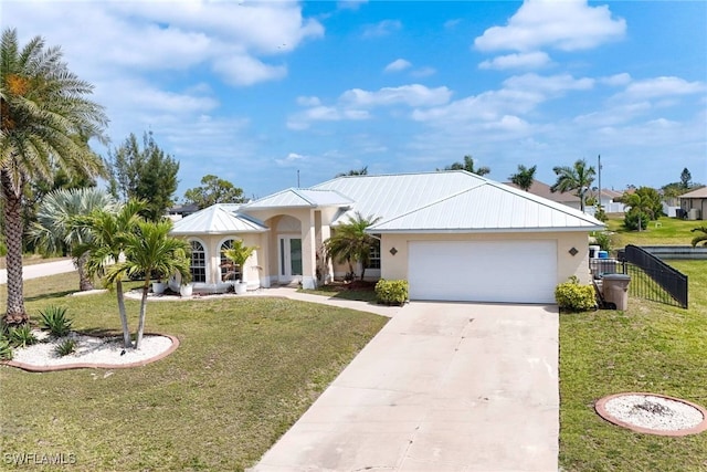 view of front of property with a front lawn, an attached garage, driveway, and stucco siding