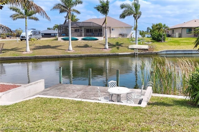 dock area featuring a lanai, a lawn, and a water view