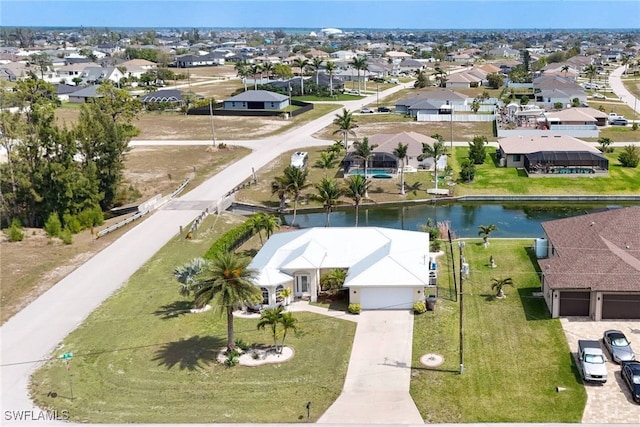 birds eye view of property featuring a residential view and a water view