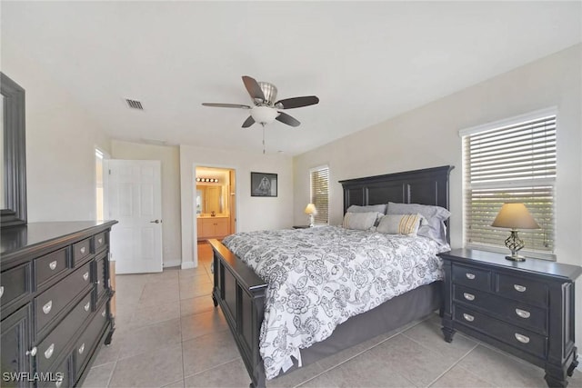 bedroom featuring light tile patterned floors, baseboards, visible vents, ceiling fan, and connected bathroom