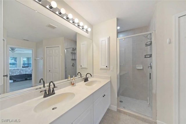 full bath featuring tile patterned flooring, a shower stall, visible vents, and a sink