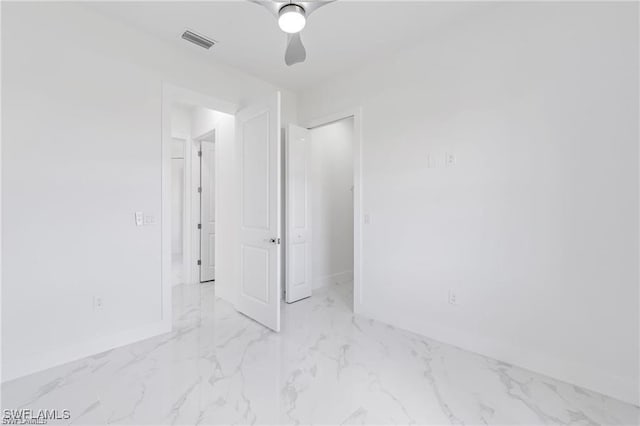 unfurnished bedroom with a ceiling fan, visible vents, baseboards, marble finish floor, and a closet