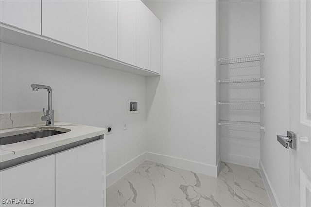 laundry area featuring cabinet space, washer hookup, marble finish floor, and a sink