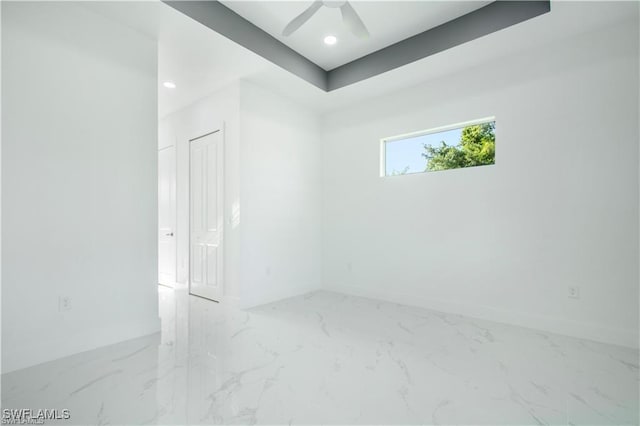 spare room with marble finish floor, baseboards, a ceiling fan, and recessed lighting