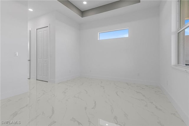 unfurnished room featuring recessed lighting, marble finish floor, and baseboards